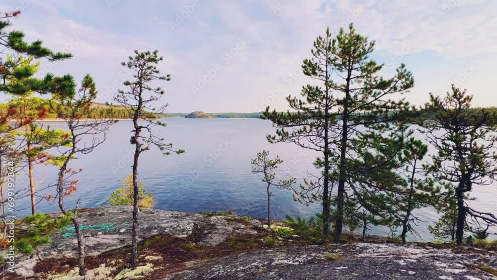 Russia, Karelia, Lake Ladoga, Koyonsaari. View of the coast of the island in a cold lake. Beautiful nature of the Republic of Karelia. Stunning panoramic view of the Ladoga Skerry Islands. 4K Russia, Karelia, Lake Ladoga, Koyonsaari. View of the coast of the island in a cold lake. Beautiful nature of the Republic of Karelia. Stunning panoramic view of the Ladoga Skerry Islands. 4K