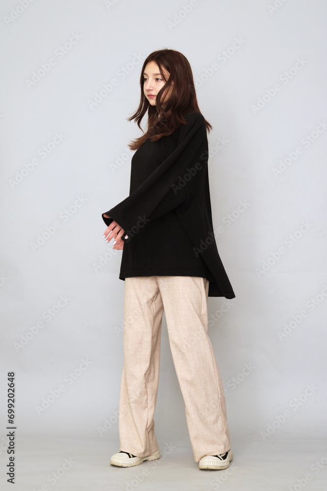 Teenager in an expansive pose, a statement of confidence. Reflects a moment of self-assuredness and independence. Teenager in an expansive pose, a statement of confidence. Reflects a moment of self-assuredness and independence.