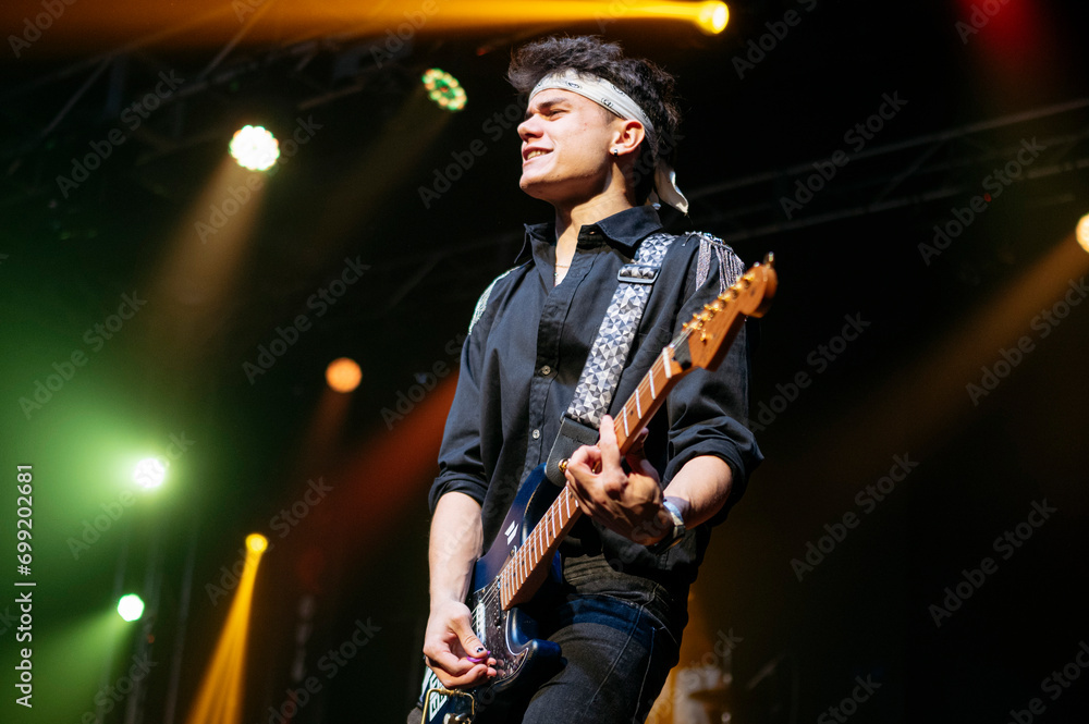 Guitarist performing at a live concert. Guitarist performing at a live concert.