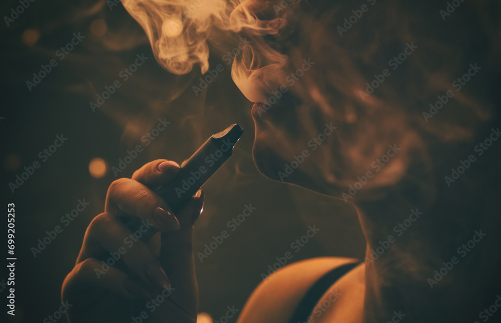a woman with a beautiful make-up, with plump lips smokes a cigarette close-up. - obrazy, fototapety, plakaty 