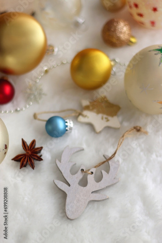 Various colorful Christmas oranments and white faux fur blanket. Selective focus. photo