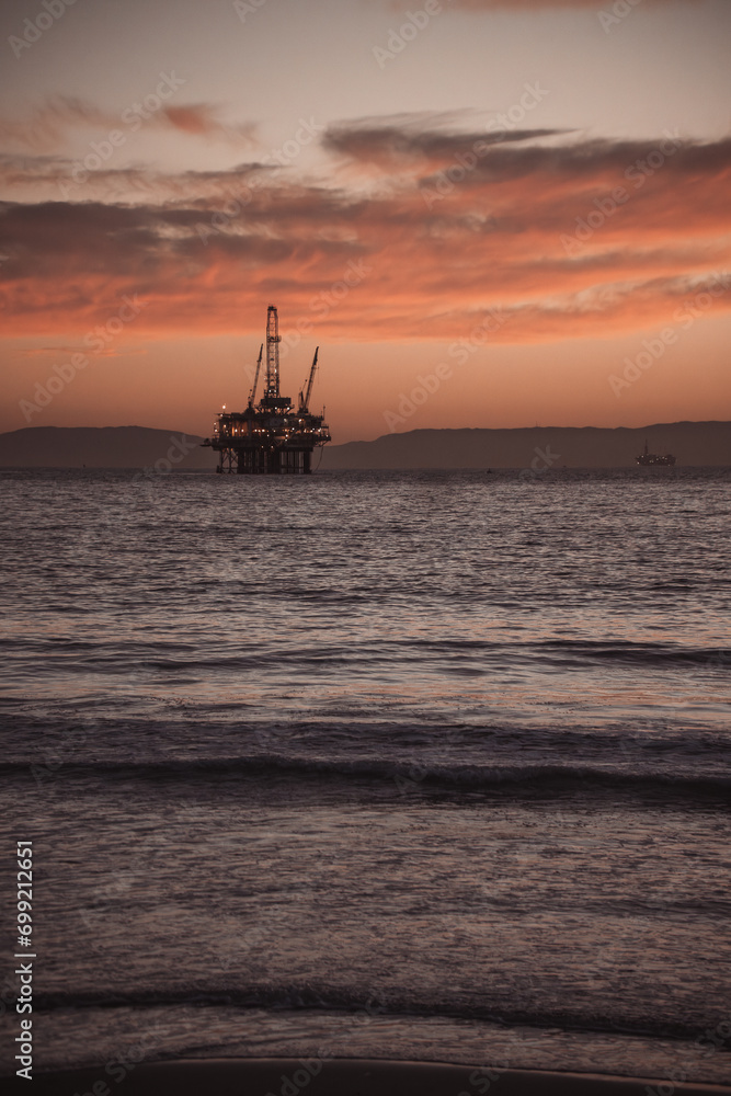 oil rig at sunset beach