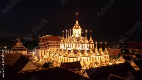 Golden metal castle illuminated, Wat Ratchanatdaram Woravihara, Loha Prasat temple in the morning at Bangkok, Thailand photo