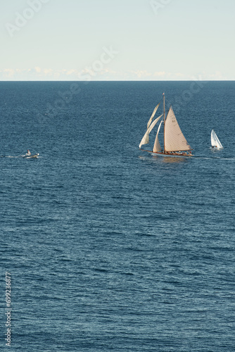 Monaco, lonely vintage sail yacht in sea at sunset, huge sail boat, wealth life of billionaires 