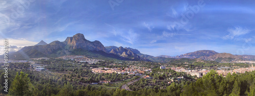 Panoramic view of the mountains and a small European town at the foot of the mountains
