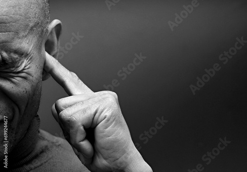 deafness suffering from hearing loss on grey black background with people stock image stock photo	 photo