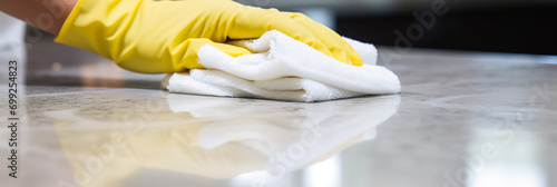 Close up of cleaning staff using a cloth for cleaning marble floor photo
