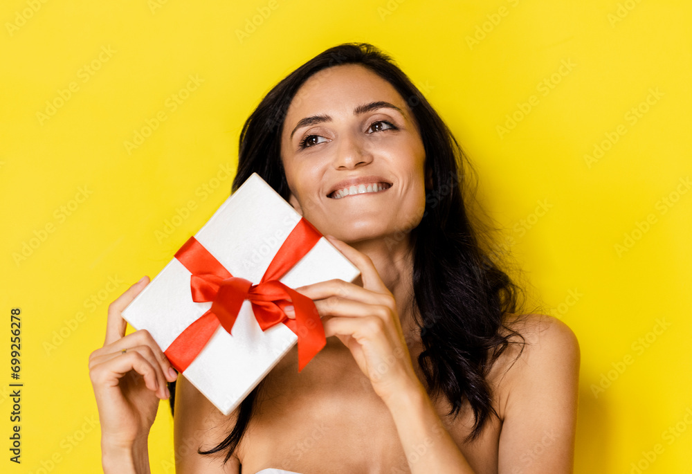 Woman holding white present box with red gift ribbon bow Woman holding white present box with red gift ribbon bow