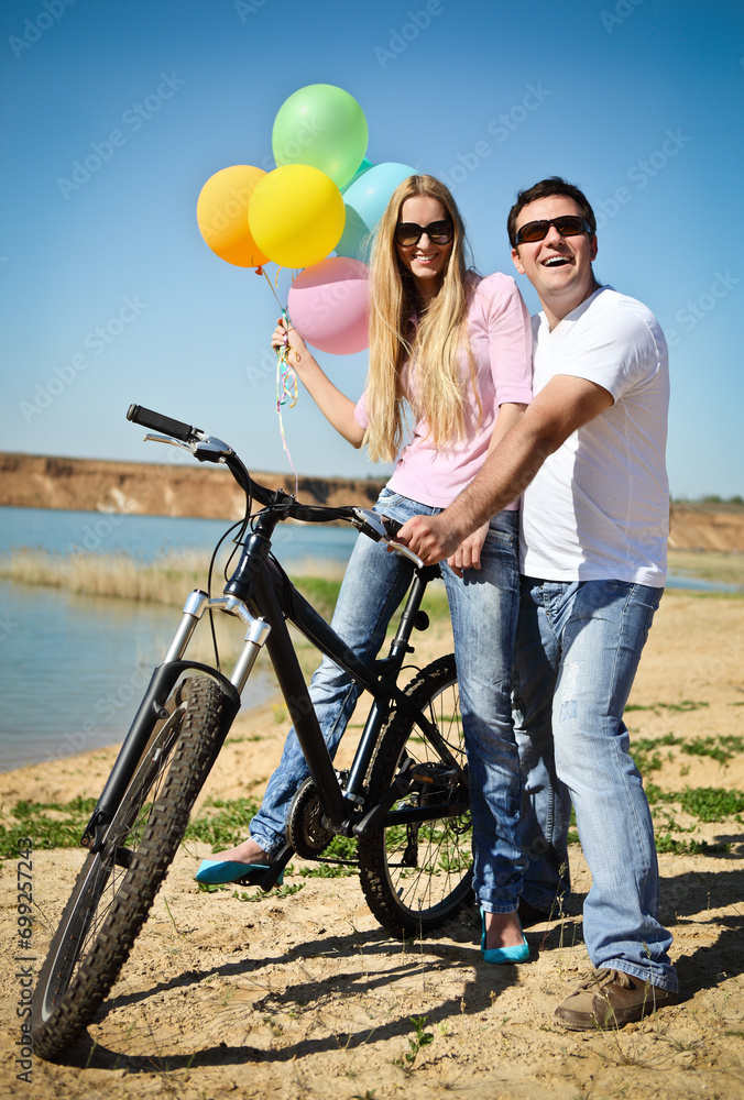 Happy smiling couple on bicycle