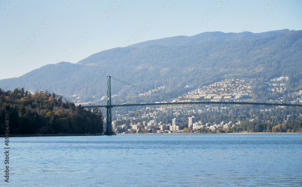 Beautiful view of the Lions Gate Bridge connecting the North Shore with Downtown Vancouver as seen from Stanley Park during a fall season in Vancouver, British Columbia, Canada Beautiful view of the Lions Gate Bridge connecting the North Shore with Downtown Vancouver as seen from Stanley Park during a fall season in Vancouver, British Columbia, Canada