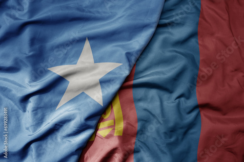 big waving national colorful flag of mongolia and national flag of somalia .
