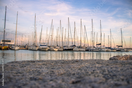 Yachts in the port, sailboats modern water transport. Beautiful moored sail yachts in the sea