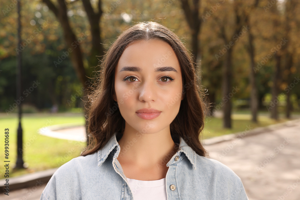 Portrait of beautiful young woman in park Portrait of beautiful young woman in park
