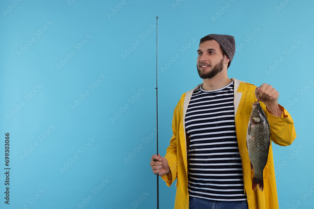 Fisherman with rod and catch on light blue background, space for text Fisherman with rod and catch on light blue background, space for text