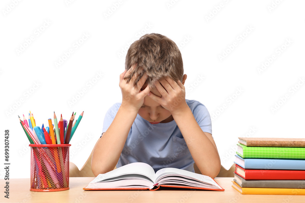 Little boy with stationery and books suffering from dyslexia at wooden table Little boy with stationery and books suffering from dyslexia at wooden table