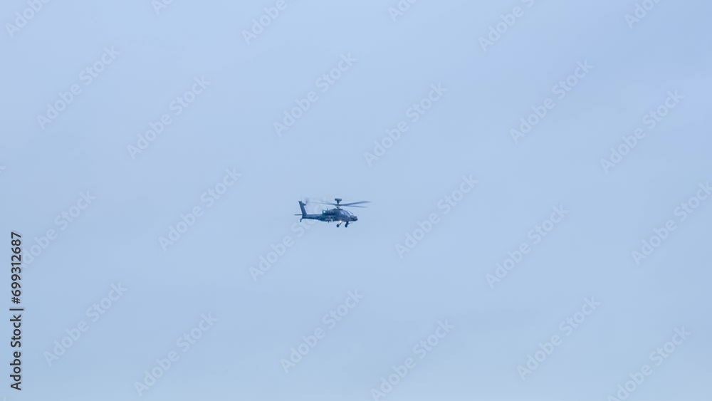 British army Boeing Apache Attack helicopter gunship AH64E (AH-64E ArmyAir606) in low level flight, Wiltshire UK British army Boeing Apache Attack helicopter gunship AH64E (AH-64E ArmyAir606) in low level flight, Wiltshire UK