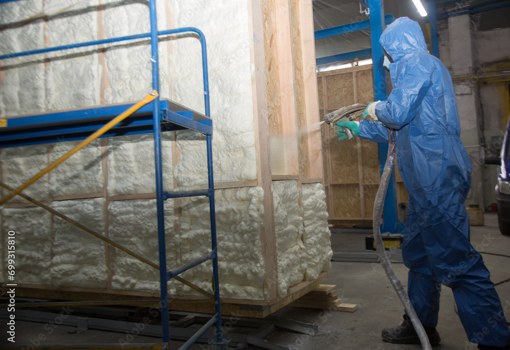 Insulation of walls with foam, energy and heat saving of walls, worker treats walls with foam Insulation of walls with foam, energy and heat saving of walls, worker treats walls with foam