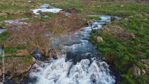 A seasonal river flows under the massive snowcovered Etna volcano. Favare Santa Venera