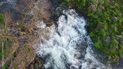 A seasonal river flows under the massive snowcovered Etna volcano. Favare Santa Venera