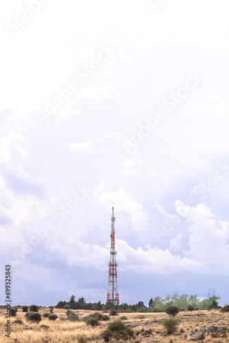 telecommunications antenna on blue background and with field around