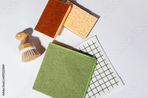 Modern cleaning supplies, dishcloth,brush and sponges, top view.