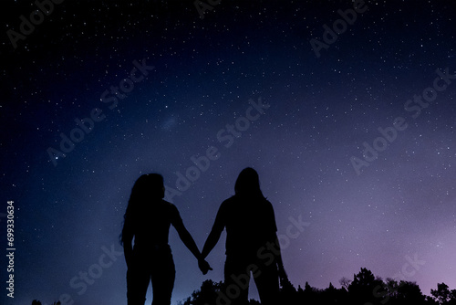 Starry night with two persons silhouette