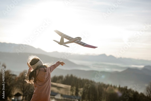 Girl playing with model glider photo