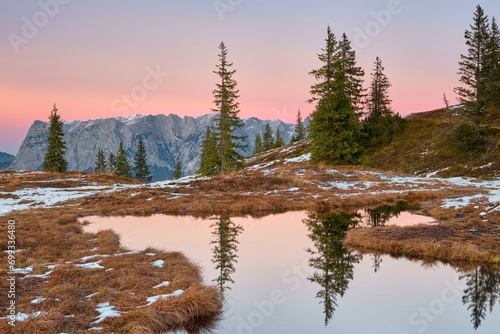 Autumn alpine pasture at sunrise, frozen water with reflection, Tennengebirge, Hochkeil, Muehlbach am Hochkoenig, Pongau photo