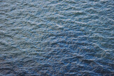 Water texture. Water Surface of a River on a Sunset with Reflections. surface of the ocean with gentle ripples on the surface and light refracting. water, lake, wave, background. Natural Water Texture
