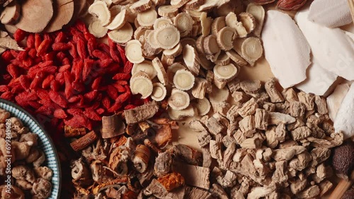 Ancient Chinese medicine and different herbal ingredients on table. photo