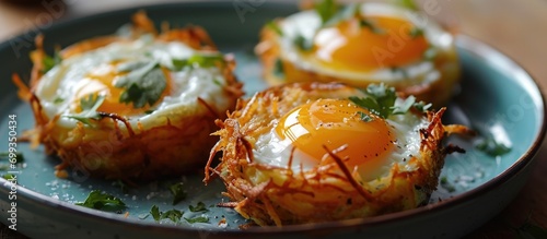 Hash brown and egg nests on a plate. photo