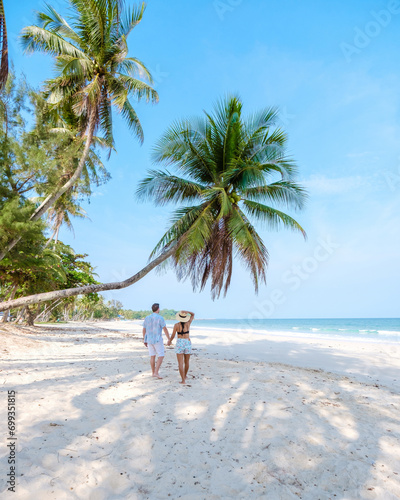 couple on vacation in Thailand, Chumpon province, white tropical beach with palm trees photo