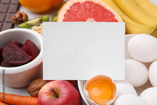 Many different products and blank card on table, closeup. Natural sources of serotonin