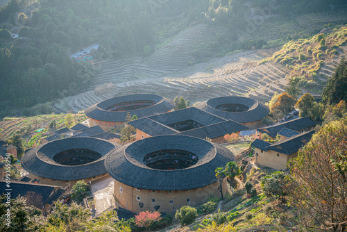 Aerial view of Tianluokeng Tulou cluster with evening mist. photo