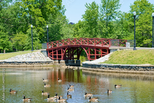 Red wooden bridge in Elm park Worcester MA USA photo