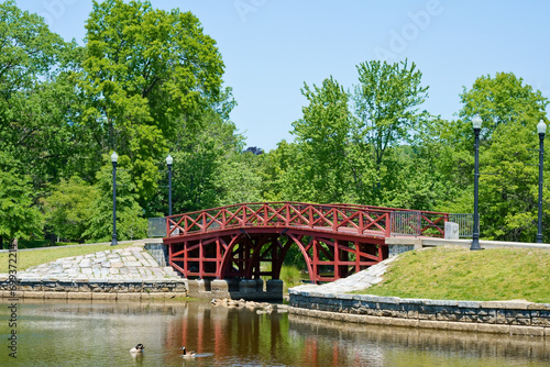 Red wooden bridge in Elm park Worcester MA USA photo