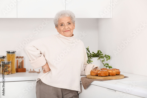 Senior woman with tasty bun...
