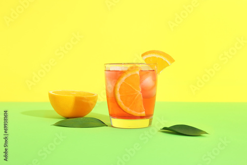 Glass of cold Negroni cocktail on color background