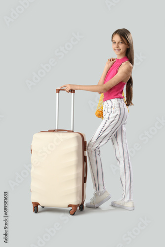 Little girl with suitcase a...