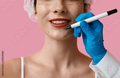 Plastic surgeon marking wom...