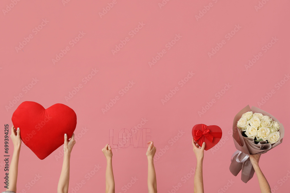 Women with gift, roses and decor on pink background. Valentine's Day celebration