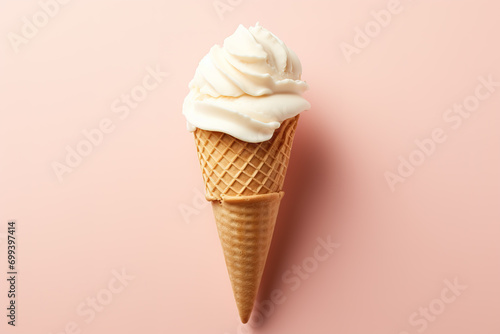 Vanilla frozen yogurt or soft ice cream in waffle cone flat lay on colored paper isolated on white background