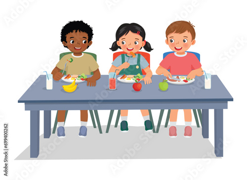 Cute kids students having lunch together at school canteen