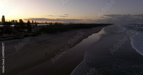 Surfers Paradise, Gold Coast, Queensland, Australia, drone,flying low alond the surf beach at sunset photo