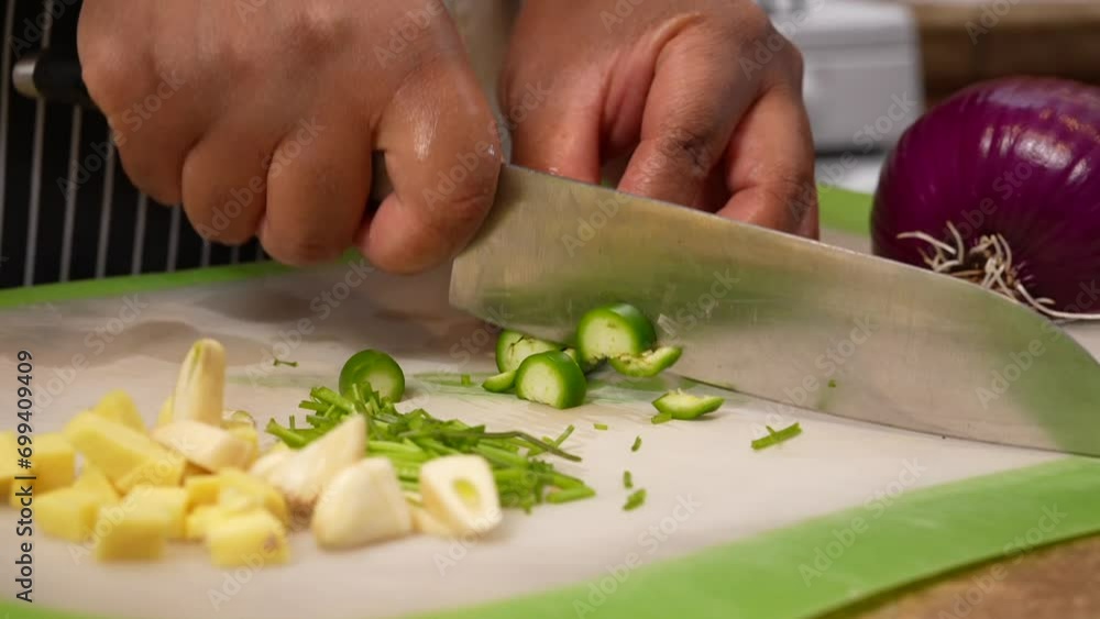 Chopping serrano peppers with ginger and garlic cloves - Chana Masala series Chopping serrano peppers with ginger and garlic cloves - Chana Masala series