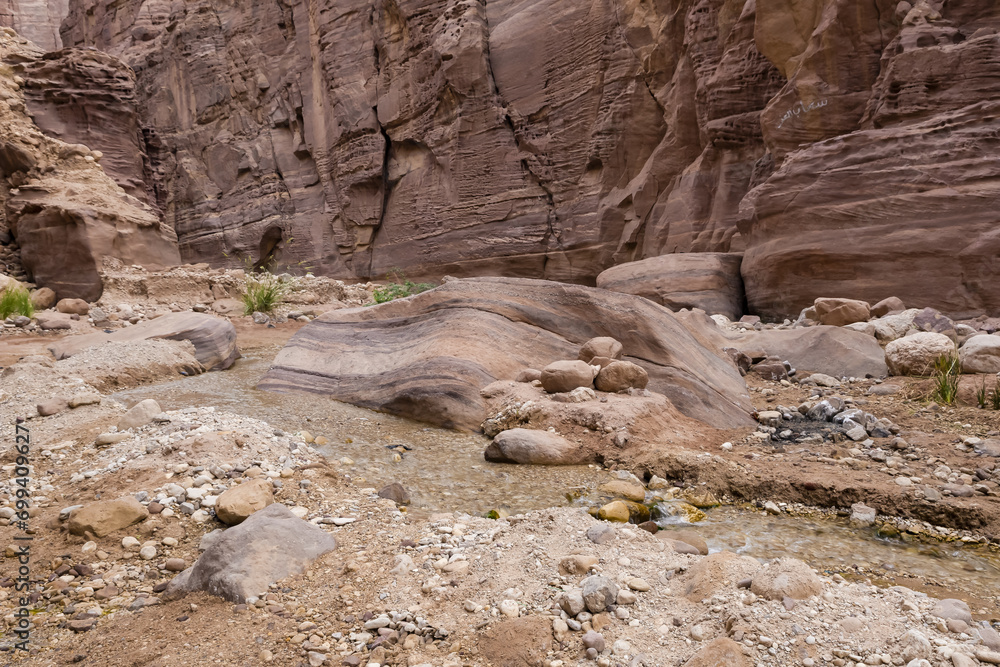 A shallow stream flows at beginning of the route along the Wadi Numeira hiking trail in Jordan A shallow stream flows at beginning of the route along the Wadi Numeira hiking trail in Jordan