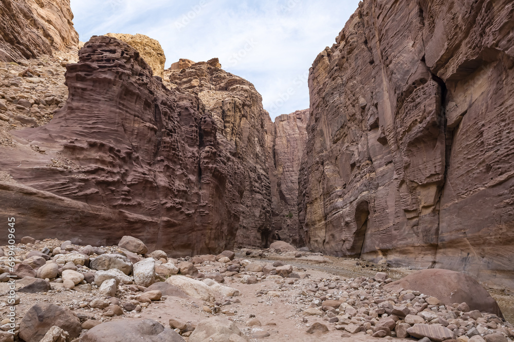 High  mountains along edges of the gorge at beginning of the walking route along the Wadi Numeira gorge in Jordan