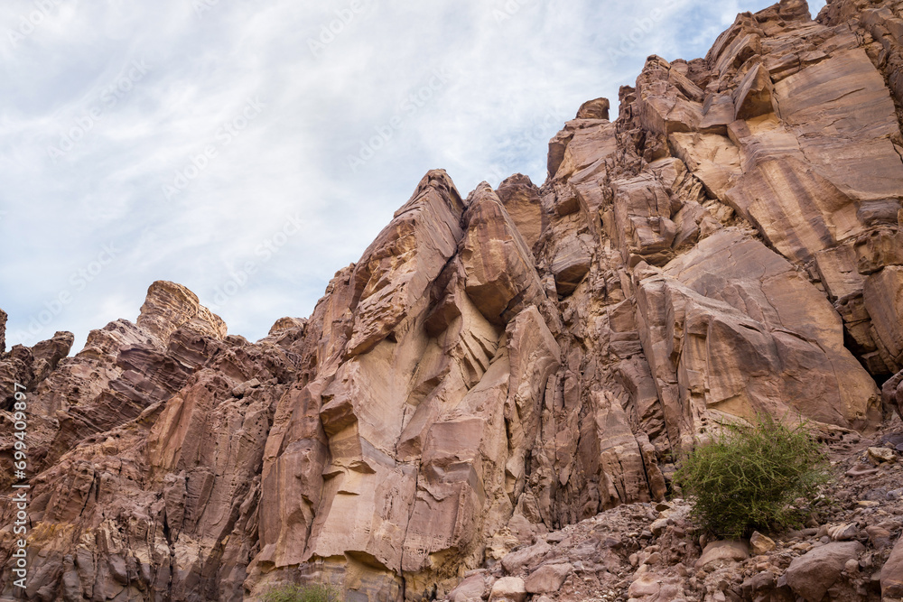 High  mountains along the edges of gorge along the hiking route along the Wadi Numeira gorge in Jordan