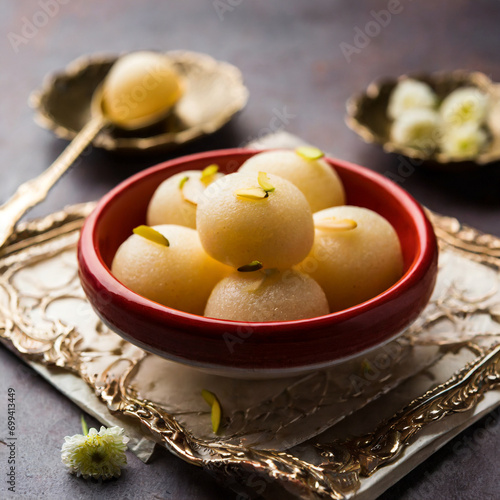 indian rasgulla or dry rosogulla dessert/sweet served in a bowl photo