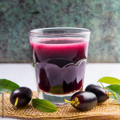 Juice of jamun fruit in a glass also called as java plum, jambolan plum, jambhul, syzygium cumini photo